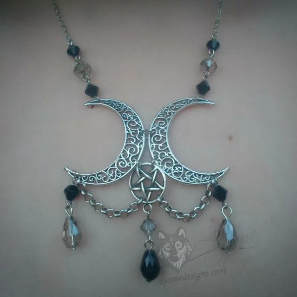 Handmade pagan triple moon necklace with filigree moons, an inverted pentacle, black and grey Austrian crystal beads, and stainless steel chain details
