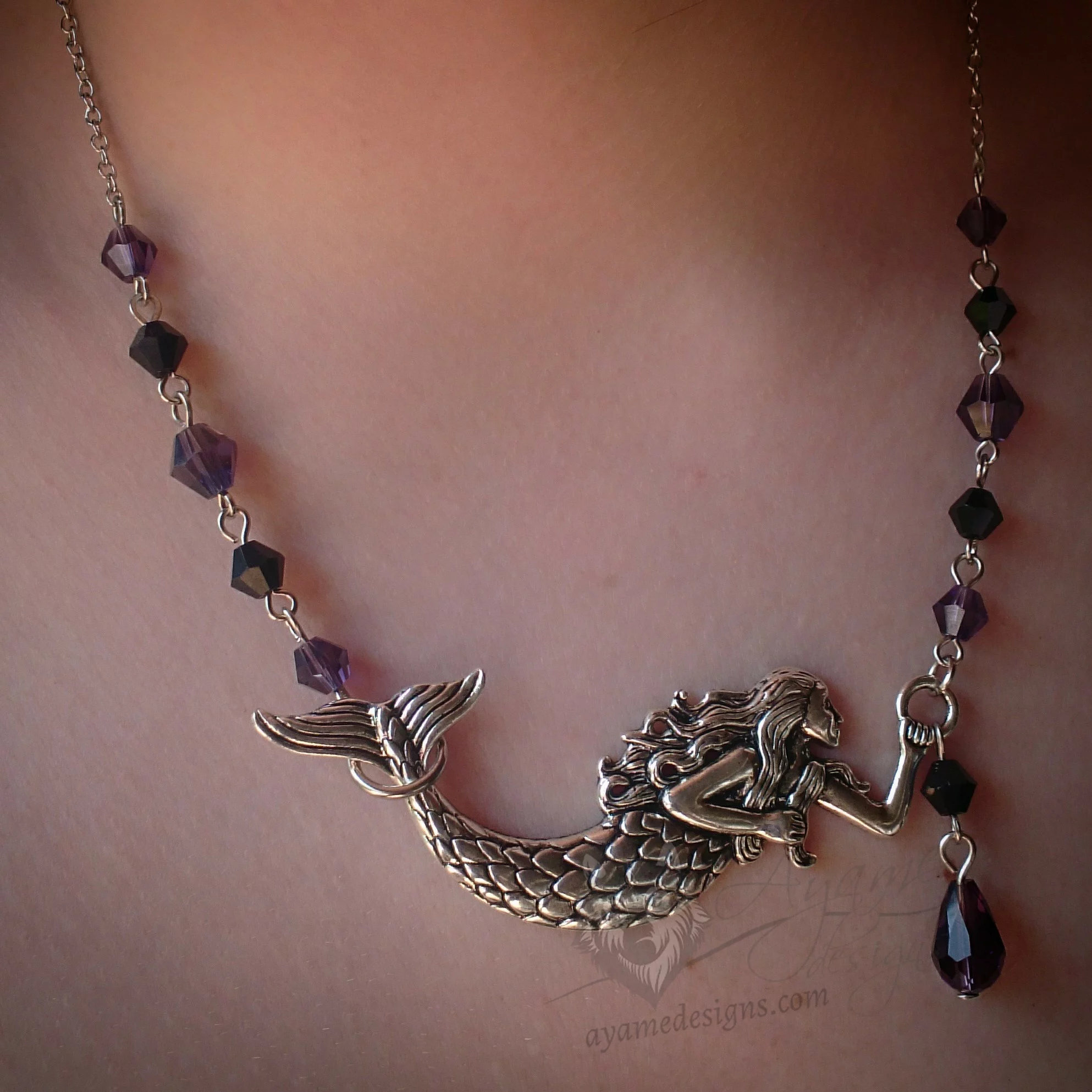 Adjustable fantasy necklace with a large mermaid pendant and black and purple Austrian crystal beads