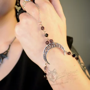 Handmade gothic hand bracelet with a filigree moon pendant, and purple and black Austrian crystal beads