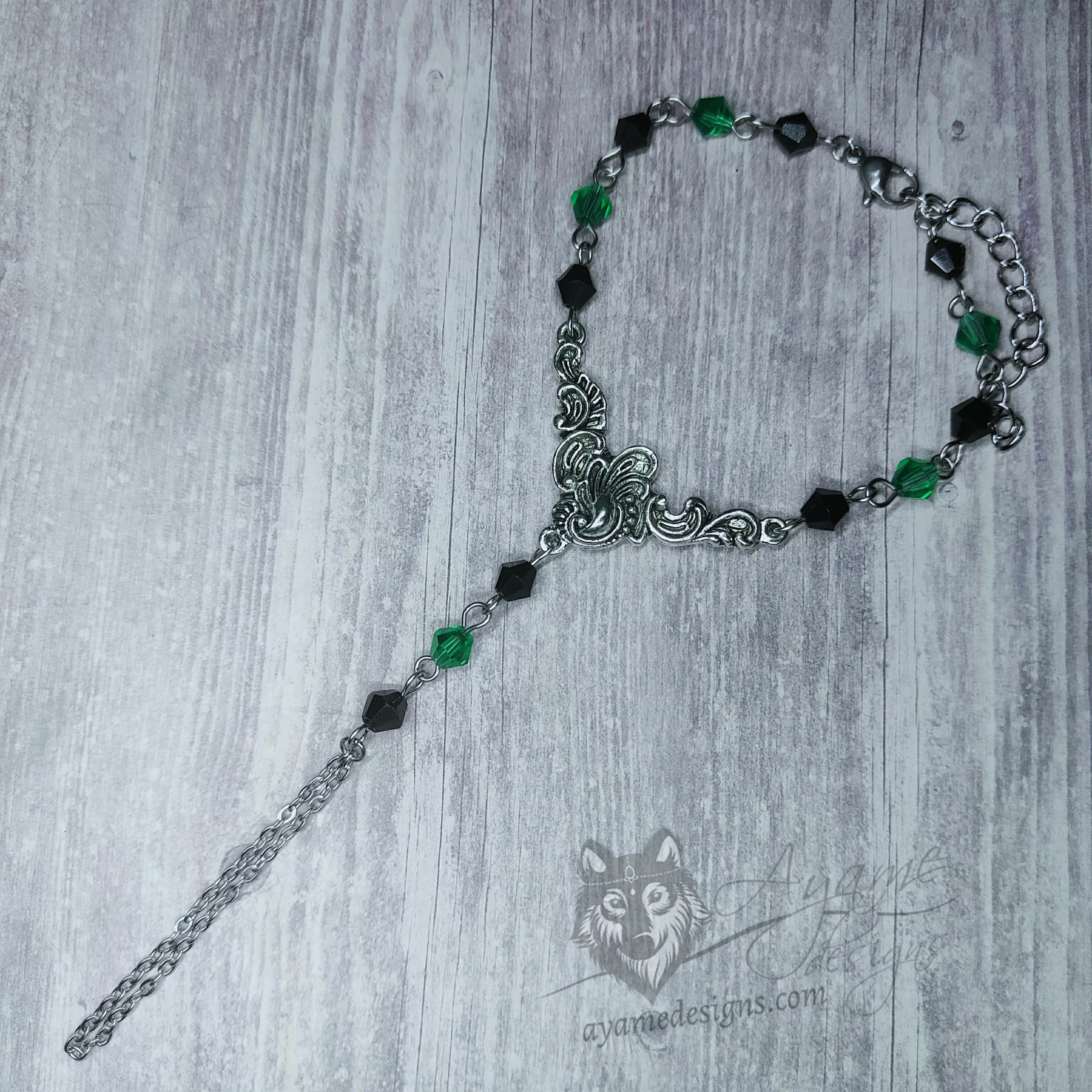 Handmade gothic hand bracelet with a filigree pendant, and black and green Austrian crystal beads
