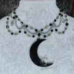 Gothic beaded choker necklace made of stainless steel with grey Czech crystal and black Austrian crystal beads, and a large laser cut perspex moon pendant