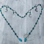 Handmade stainless steel fantasy face chain with teal and green Austrian crystal beads and stainless steel moon charms