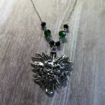 Handmade adjustable pagan necklace with a green man pendant, black and green Austrian crystal beads, and stainless steel chain