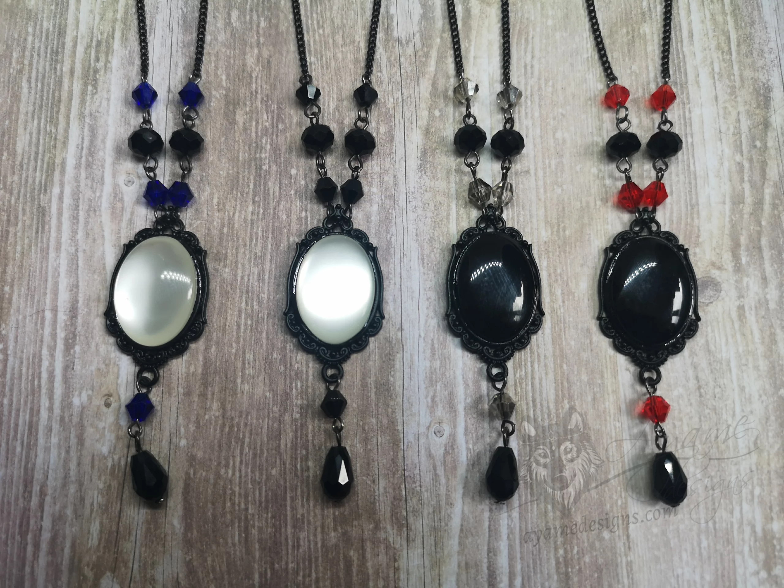 Handmade adjustable gothic necklace with a resin cabochon in a black filigree frame, Austrian crystal beads and black stainless steel chain