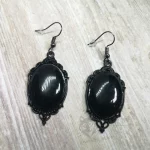 Elegant gothic earrings with black resin cabochons in black filigree frames, on stainless steel earring hooks