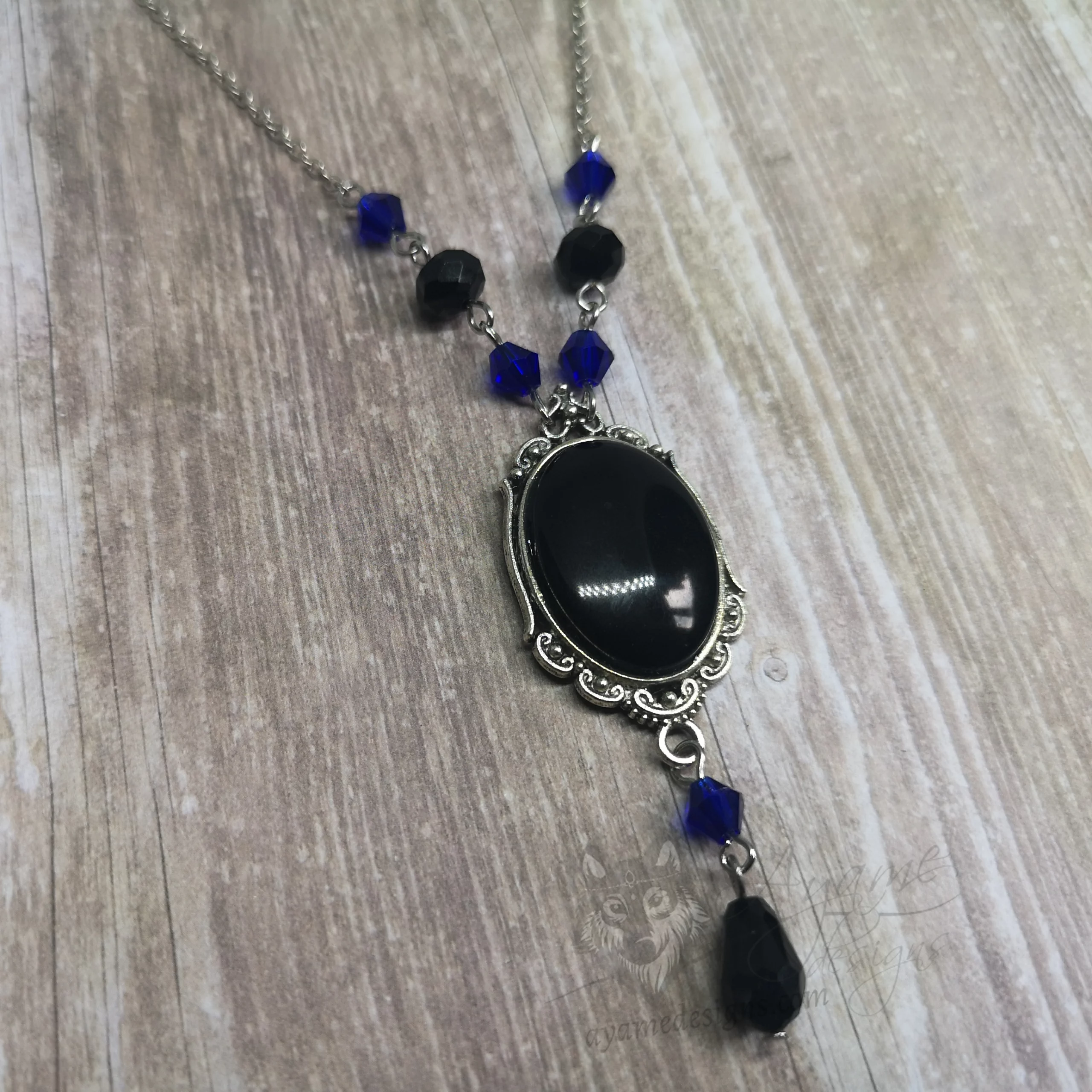 Handmade adjustable gothic necklace with a black resin cabochon in a silver filigree frame, black and blue Austrian crystal beads and silver stainless steel chain