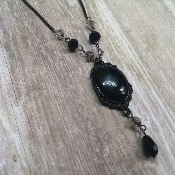 Handmade adjustable gothic necklace with a black resin cabochon in a black filigree frame, black and grey Austrian crystal beads and black stainless steel chain