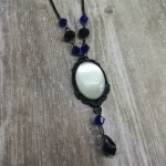 Handmade adjustable gothic necklace with a white resin cabochon in a black filigree frame, black and blue Austrian crystal beads and black stainless steel chain