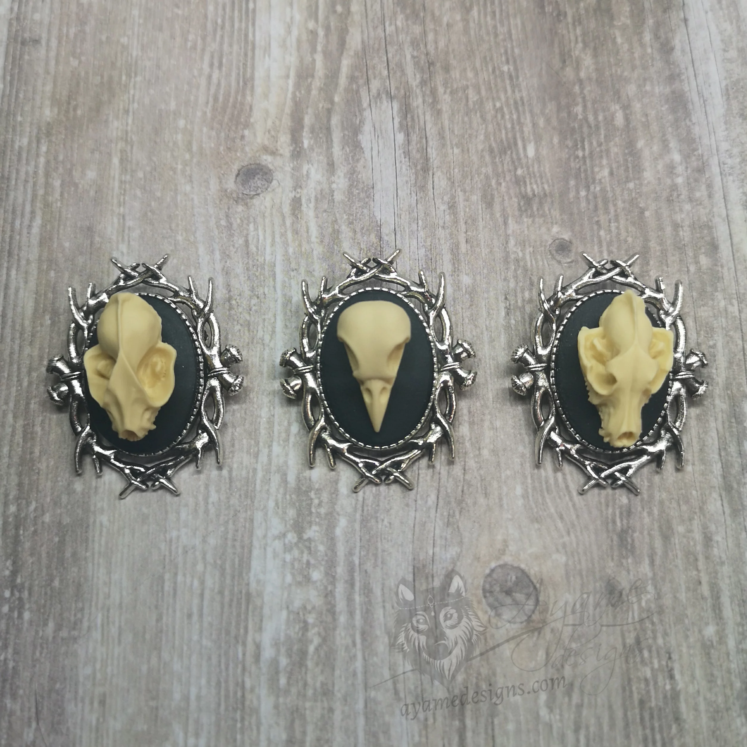 Small resin animal skull cameo brooch with a branch style frame