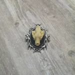 Small resin wolf skull cameo brooch with a branch style frame