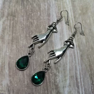 Elegant gothic earrings with hand charms and green teardrop charms, on stainless steel earring hooks