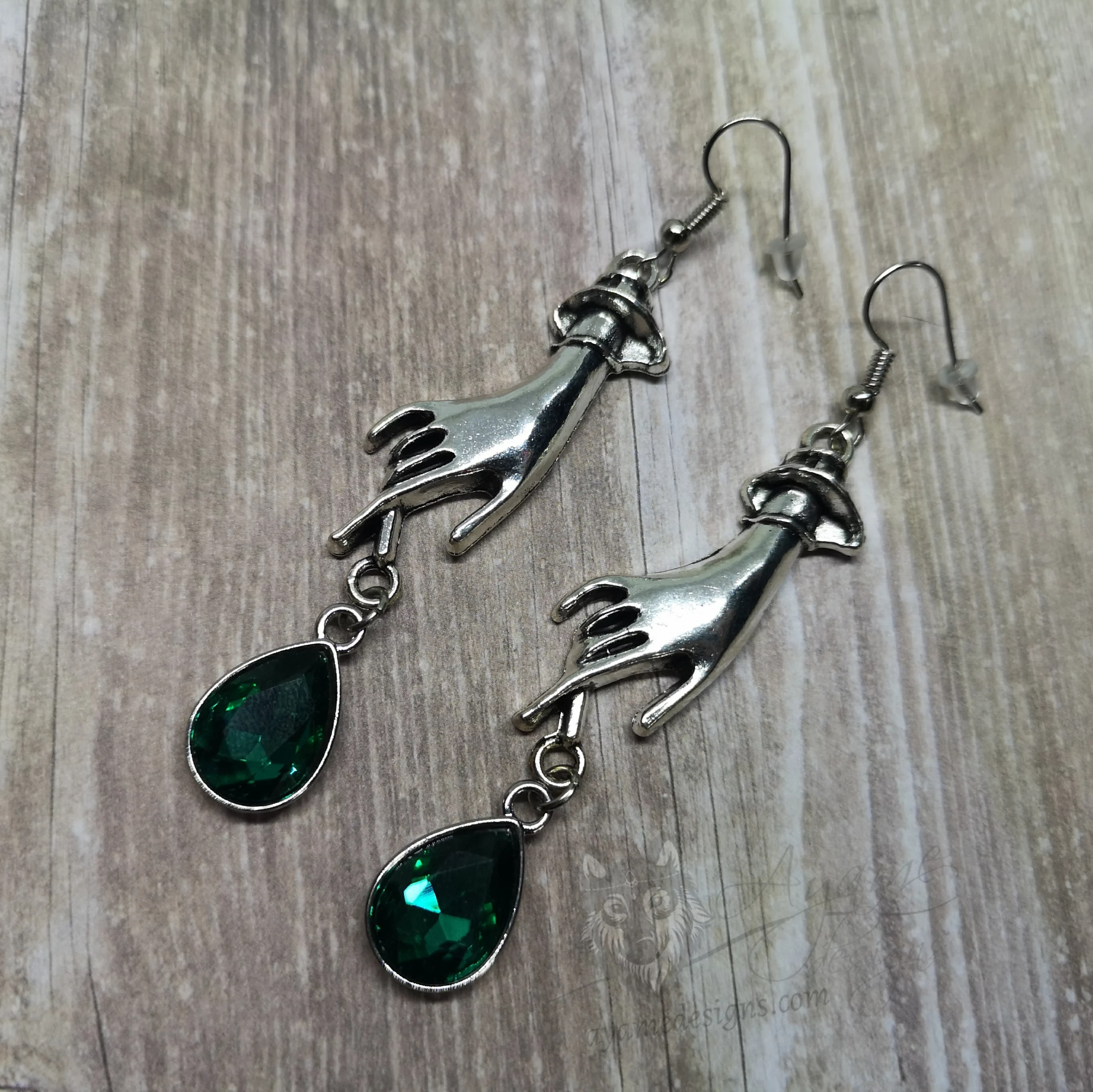 Elegant gothic earrings with hand charms and green teardrop charms, on stainless steel earring hooks