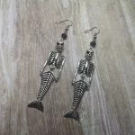Handmade earrings with mermaid skeleton pendants and purple Austrian crystal beads on stainless steel earring hooks