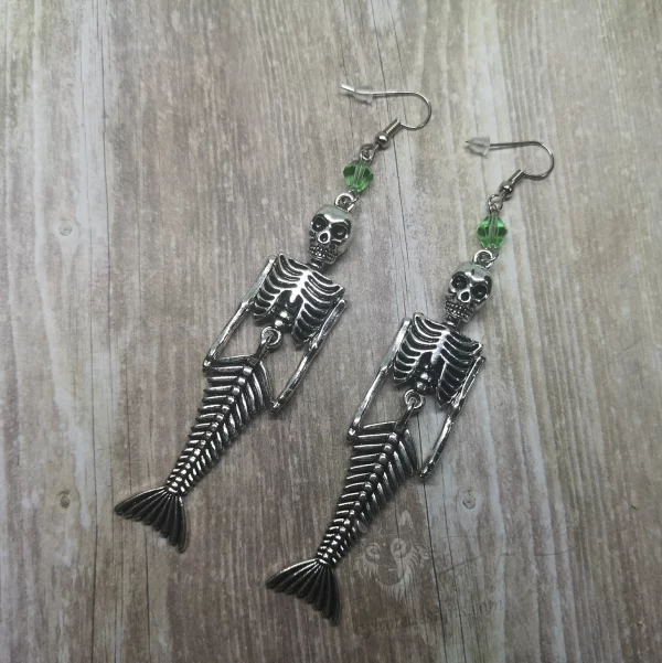 Handmade earrings with mermaid skeleton pendants and light green Austrian crystal beads on stainless steel earring hooks