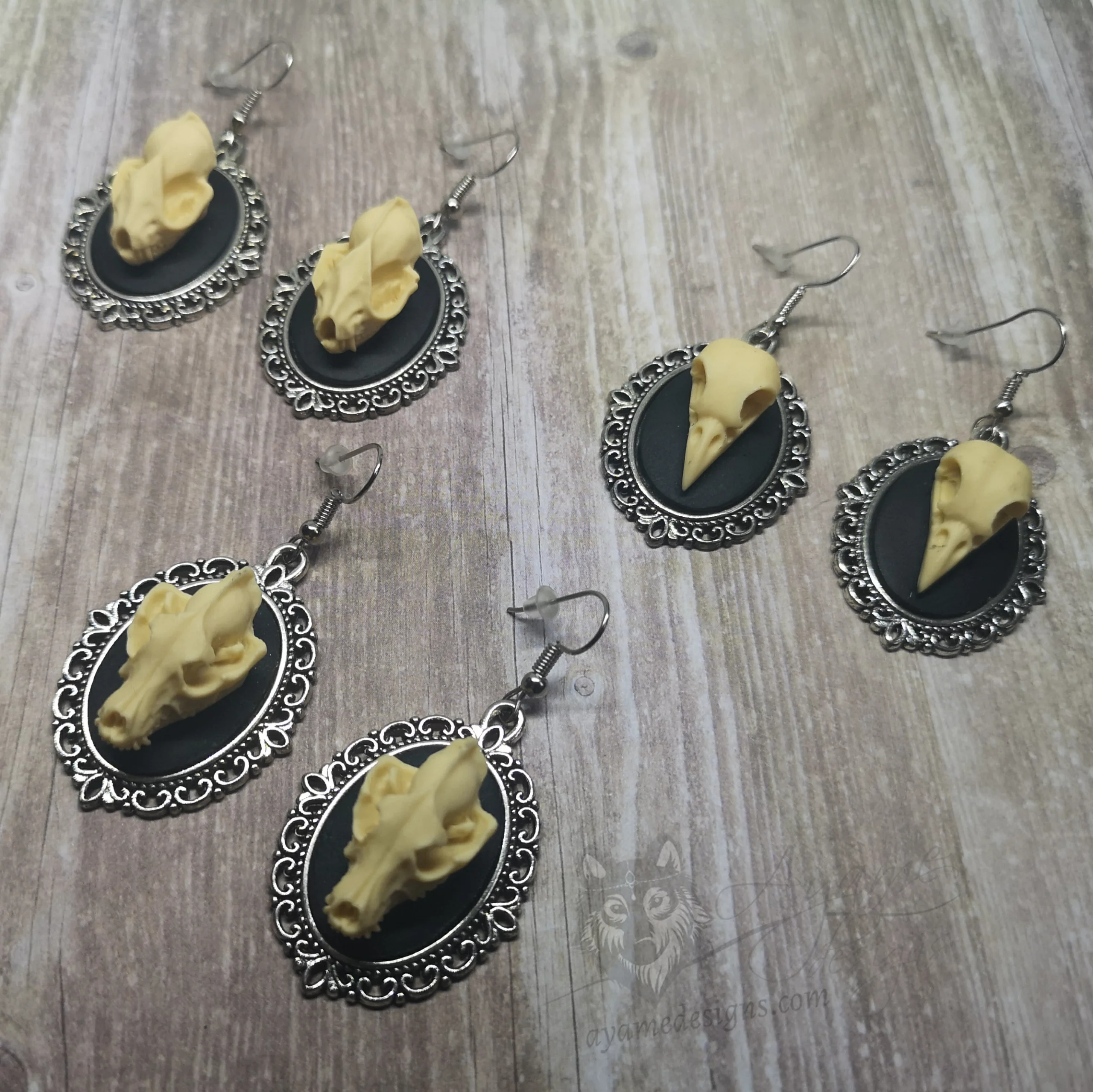 Handmade gothic earrings with resin animal skulls in filigree frames on stainless steel earring hooks