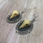 Handmade gothic earrings with resin bird skulls in filigree frames on stainless steel earring hooks