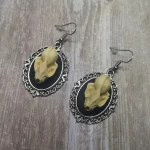Handmade gothic earrings with resin bat skulls in filigree frames on stainless steel earring hooks