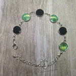 Adjustable stainless steel cabochon bracelet with black and light green resin mermaid scales
