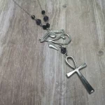 Handmade Egyptian mythology necklace with an Eye Of Horus and ankh pendant, black and purple Austrian crystal beads, and stainless steel chain