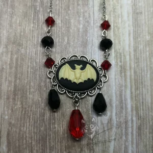 Adjustable gothic necklace with a bat cameo in a filigree frame, with black and red Austrian crystal beads and stainless steel chain
