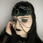 Handmade fantasy head chain with a black cabochon in a filigree chain, branch charms, green and black Austrian crystal beads and stainless steel chain
