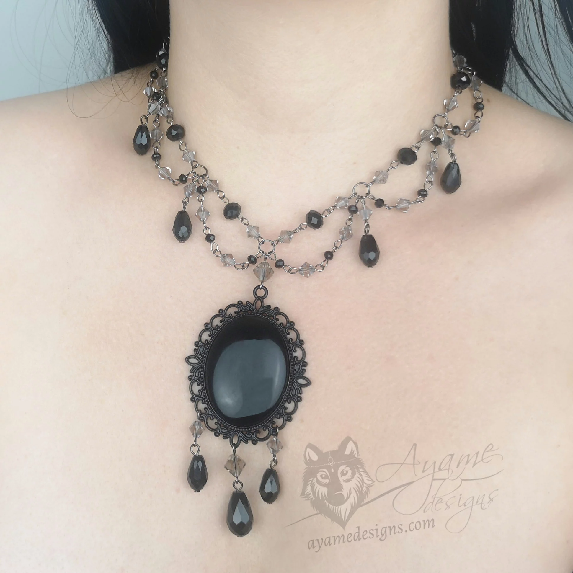 Handmade adjustable Victorian gothic choker necklace with grey and black Austrian crystal beads and a large black resin cabochon pendant in a silver filigree frame
