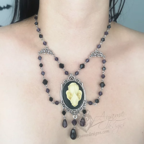 Handmade beaded choker necklace with a large resin bat skull pendant in a filigree frame, and purple and black Austrian crystal beads