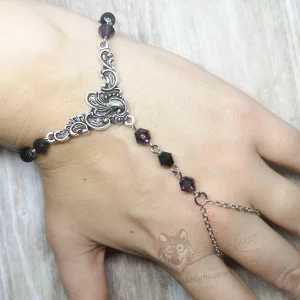 Handmade gothic hand bracelet with a filigree pendant, and purple and black Austrian crystal beads