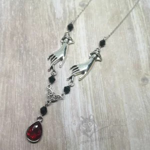 Adjustable necklace with hand pendants, a filigree connector and a red teardrop charm