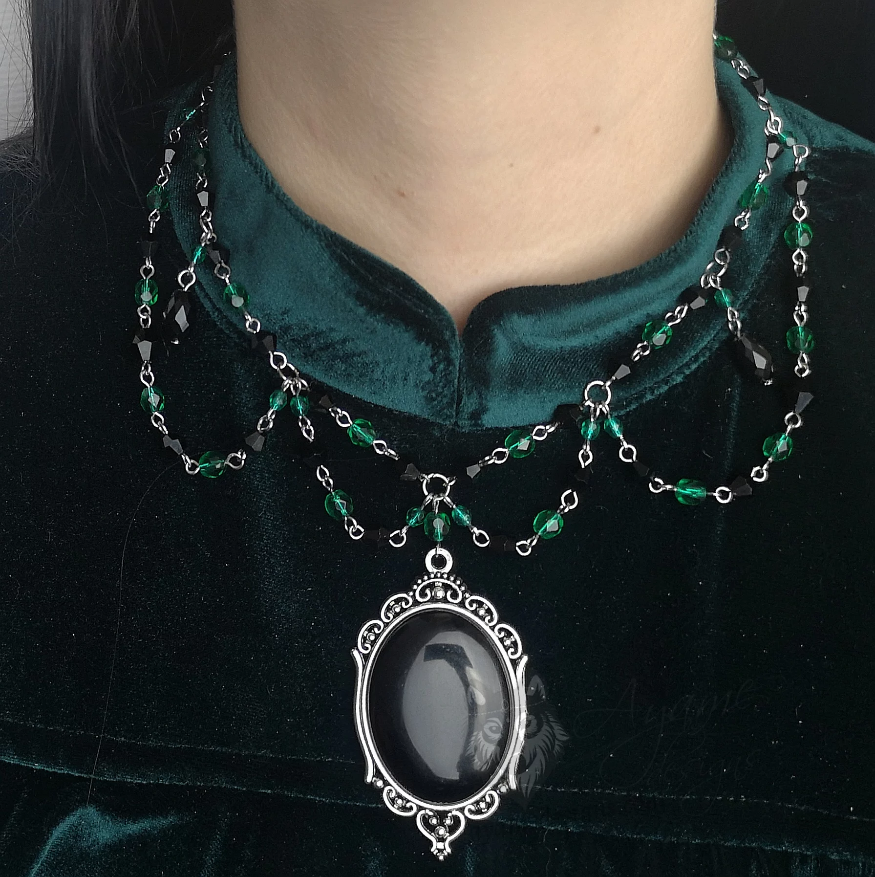 Handmade beaded choker necklace with green Czech crystal beads, black Austrian crystal beads and a large black cabochon in a filigree frame