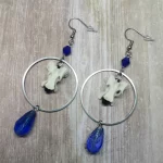 Handmade earrings with duck vertebrae inside large stainless steel rings, with blue Austrian crystal beads, on stainless steel earring hooks