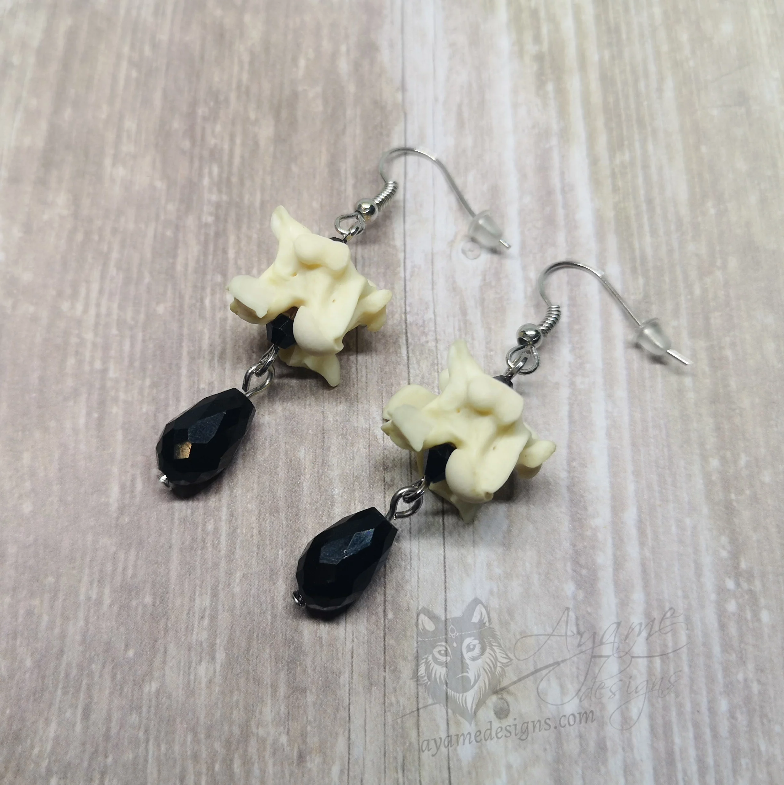 Handmade earrings with snake vertebrae and black Austrian crystal beads, on stainless steel earring hooks