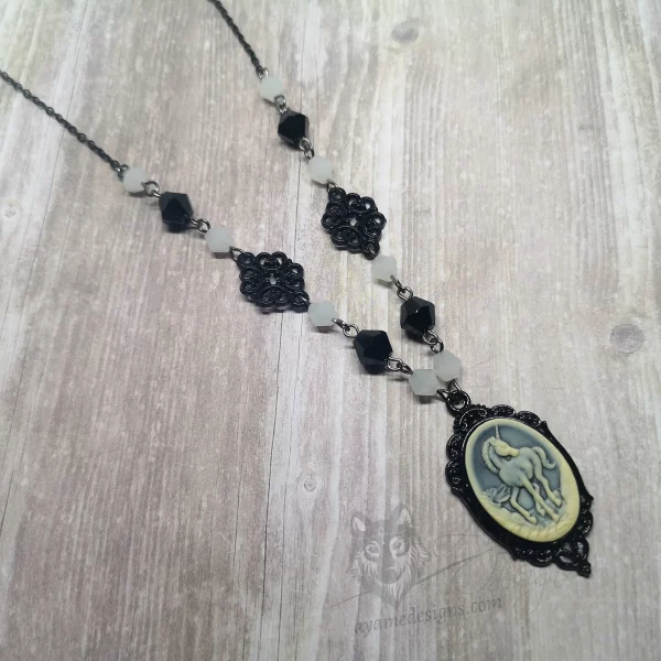 Handmade gothic necklace with a small resin unicorn cameo in a black filigree frame, white and black Austrian crystal beads and black stainless steel chain