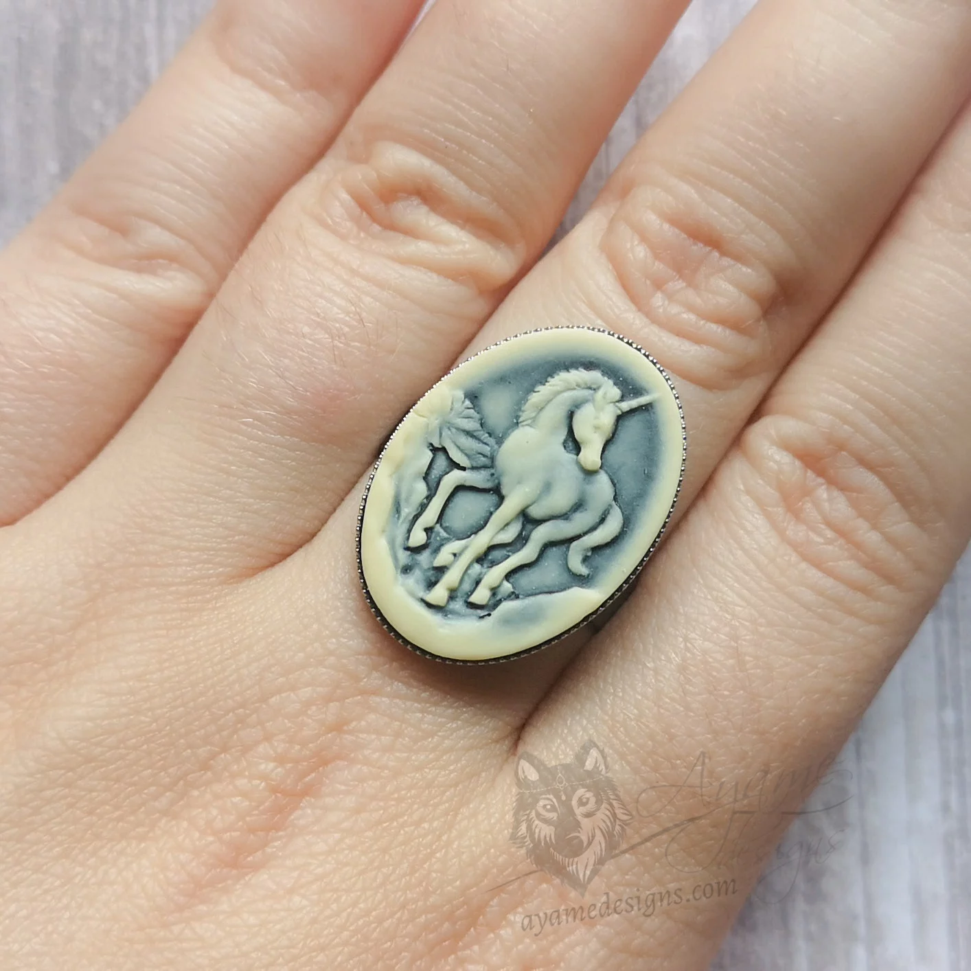 Adjustable stainless steel ring with resin unicorn cameo