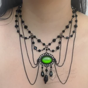 Handmade adjustable Victorian gothic choker necklace with black Austrian crystal beads and a large green resin cabochon pendant in a black filigree frame, and fine black chain details