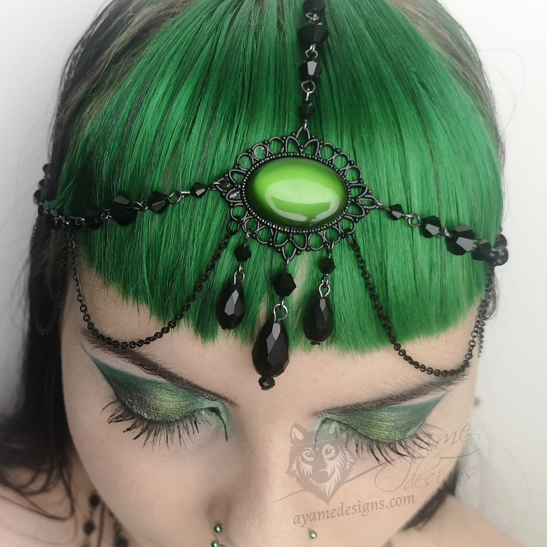 Handmade gothic head chain with a green resin cabochon in a black filigree frame, black Austrian crystal beads and black stainless steel chain