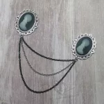 Collar pins with resin wolf cameos in filigree frames, and 2 strands of black chain, 1 strand of silver chain