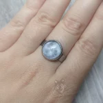 Adjustable stainless steel ring with glass moon cabochon
