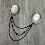 Collar pins with white resin cabochons in filigree frames, and 2 strands of chains and 1 strand of grey and black Austrian crystal beads