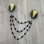 Collar pins with resin bird skulls in filigree frames, and 3 strands of black Austrian crystal beads