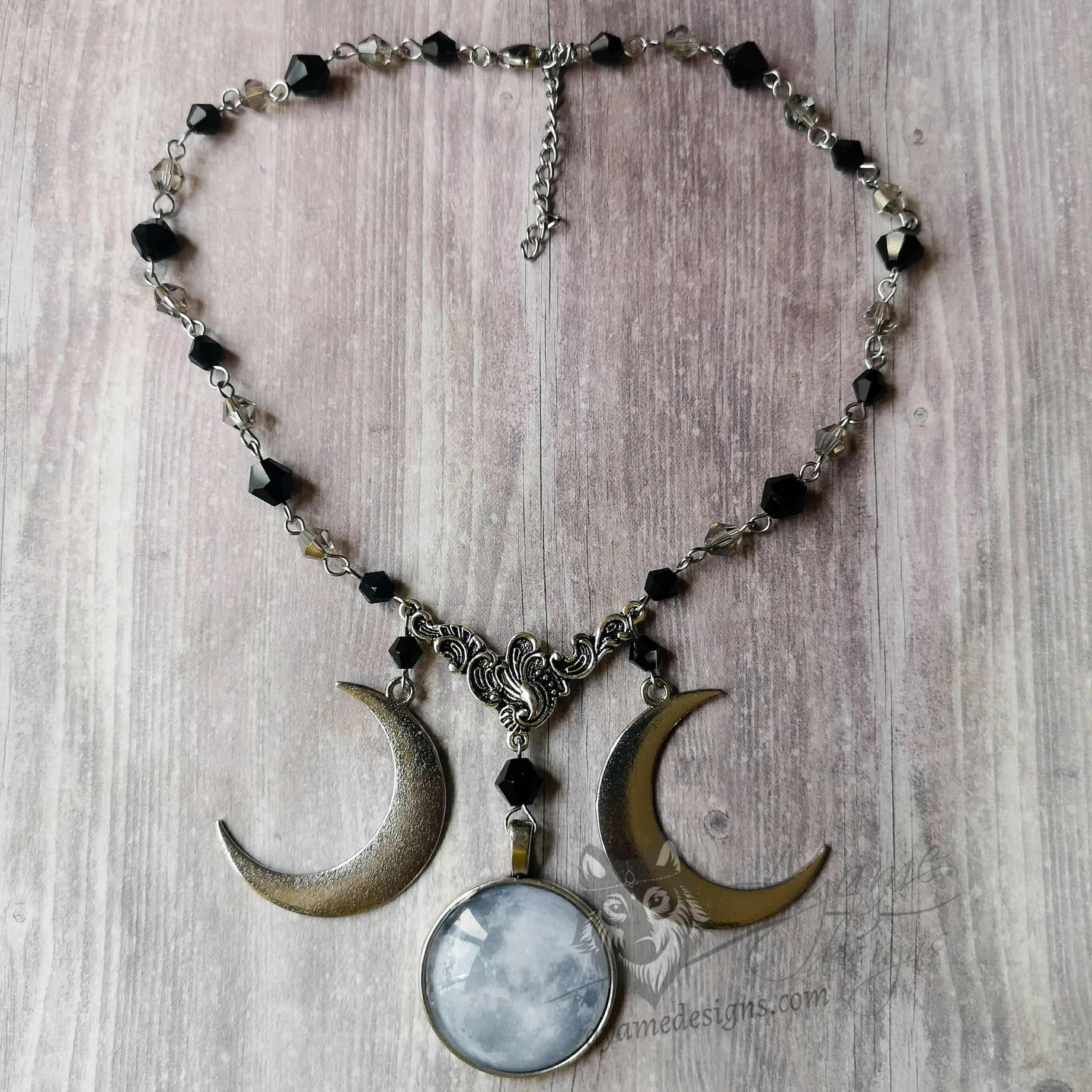 Gothic beaded choker necklace with grey and black Austrian crystal beads, a glass moon cabochon pendant, and a crescent moon pendant on each side
