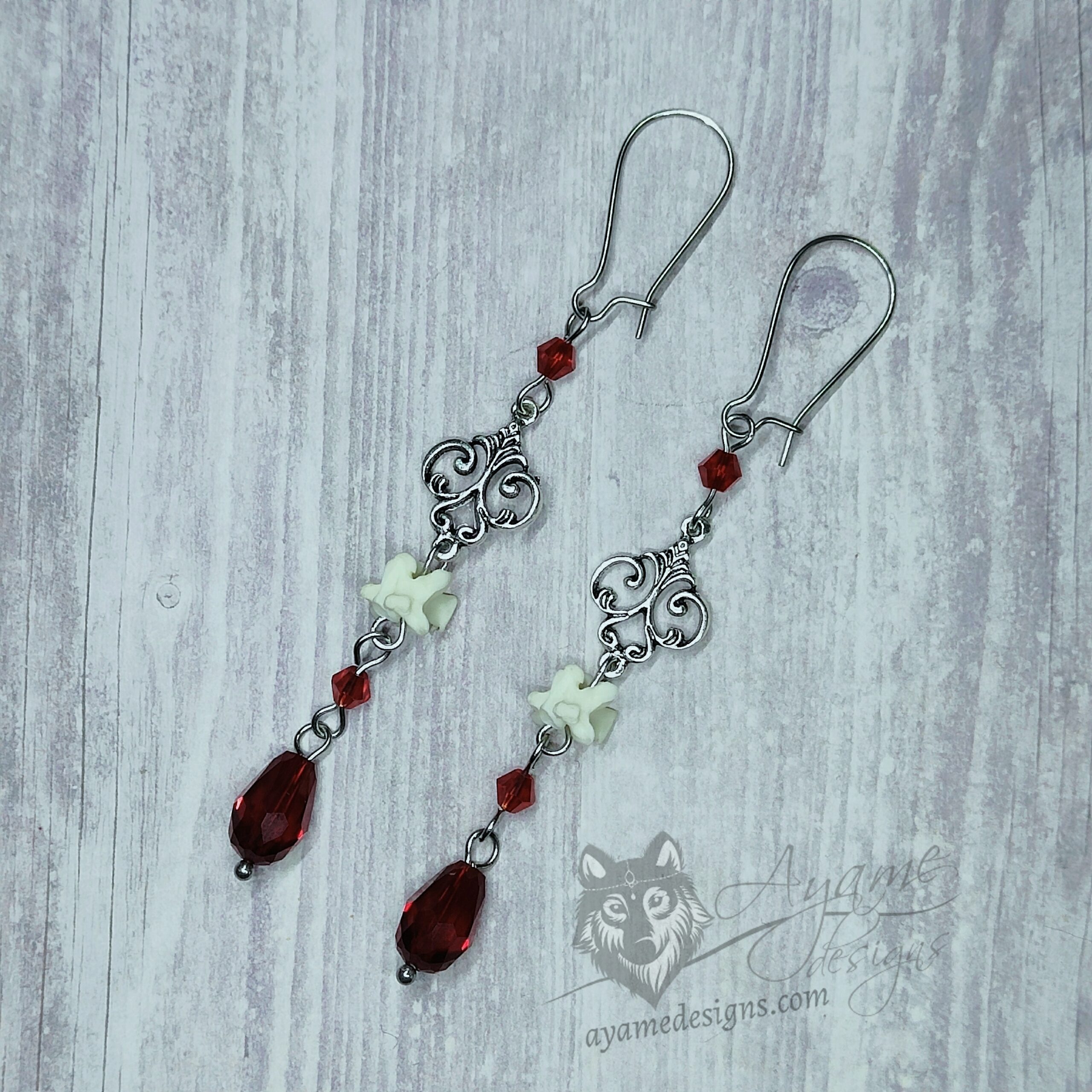 Handmade Victorian gothic earrings with filigrees, tiny snake vertebrae and red Austrian crystal beads on stainless steel earring hooks