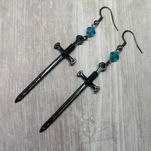 Handmade fantasy earrings with black sword pendants, teal Austrian crystal beads and stainless steel earring hooks