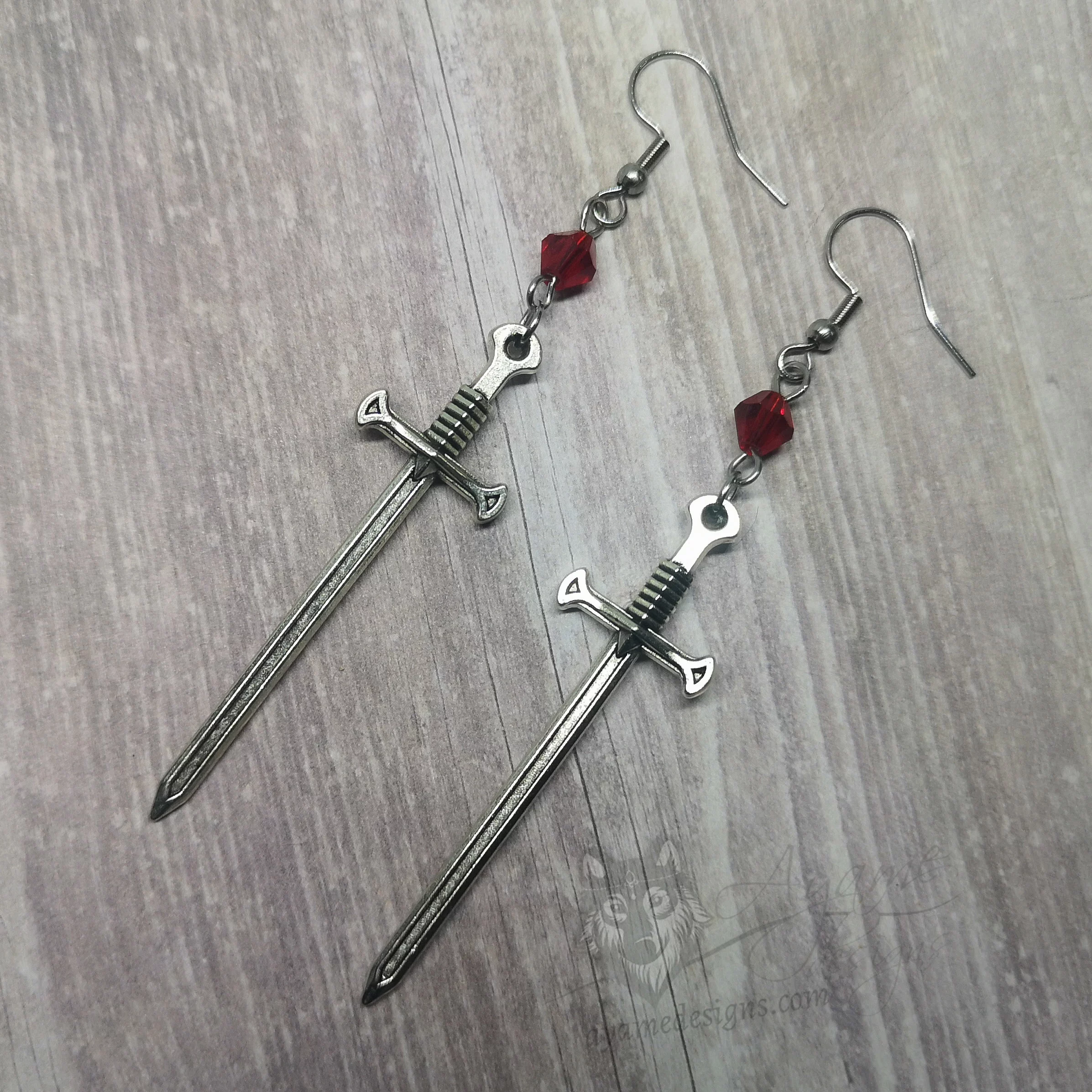 Handmade fantasy earrings with silver sword pendants, red Austrian crystal beads and stainless steel earring hooks