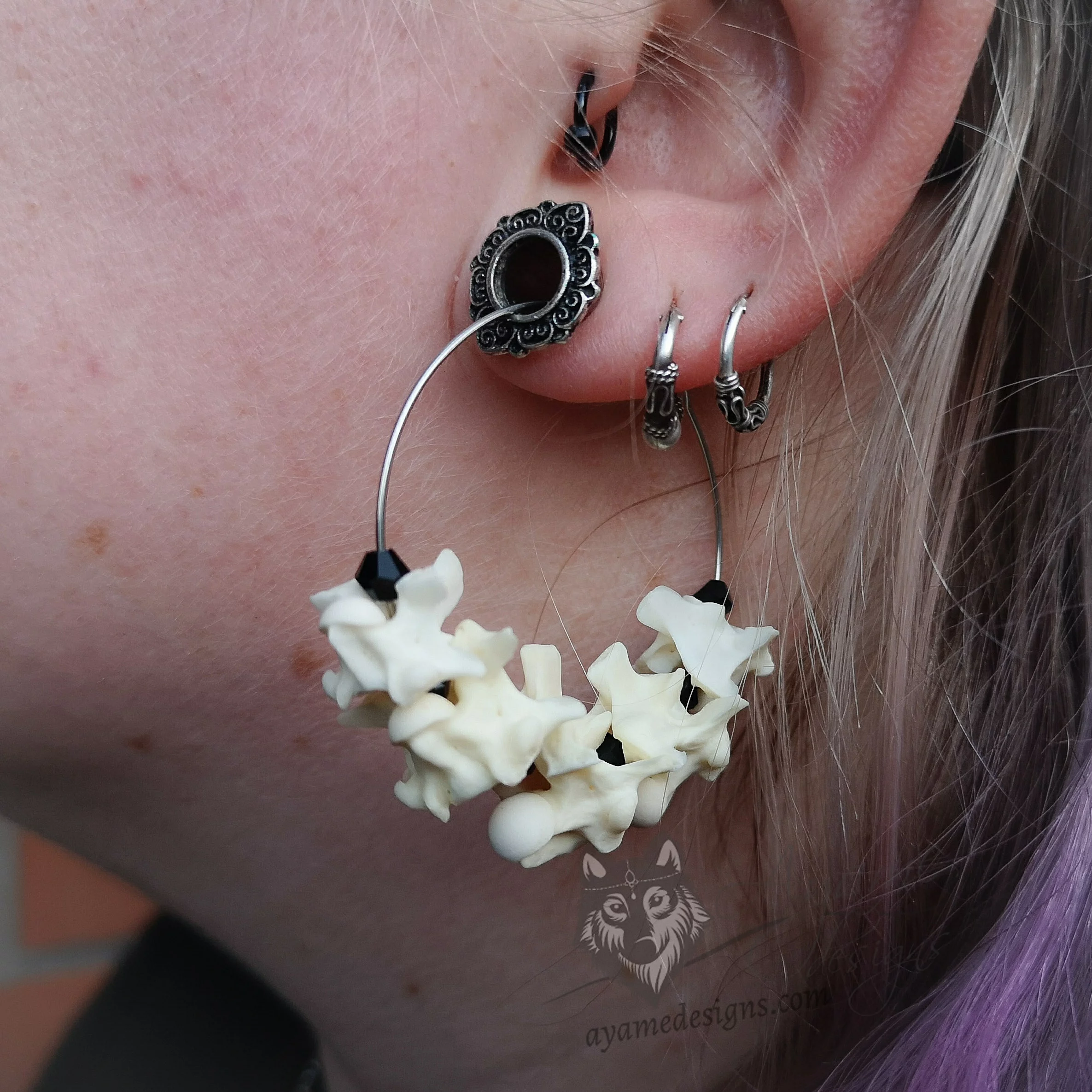Handmade stainless steel hoop earrings with snake vertebrae and black Austrian crystal beads