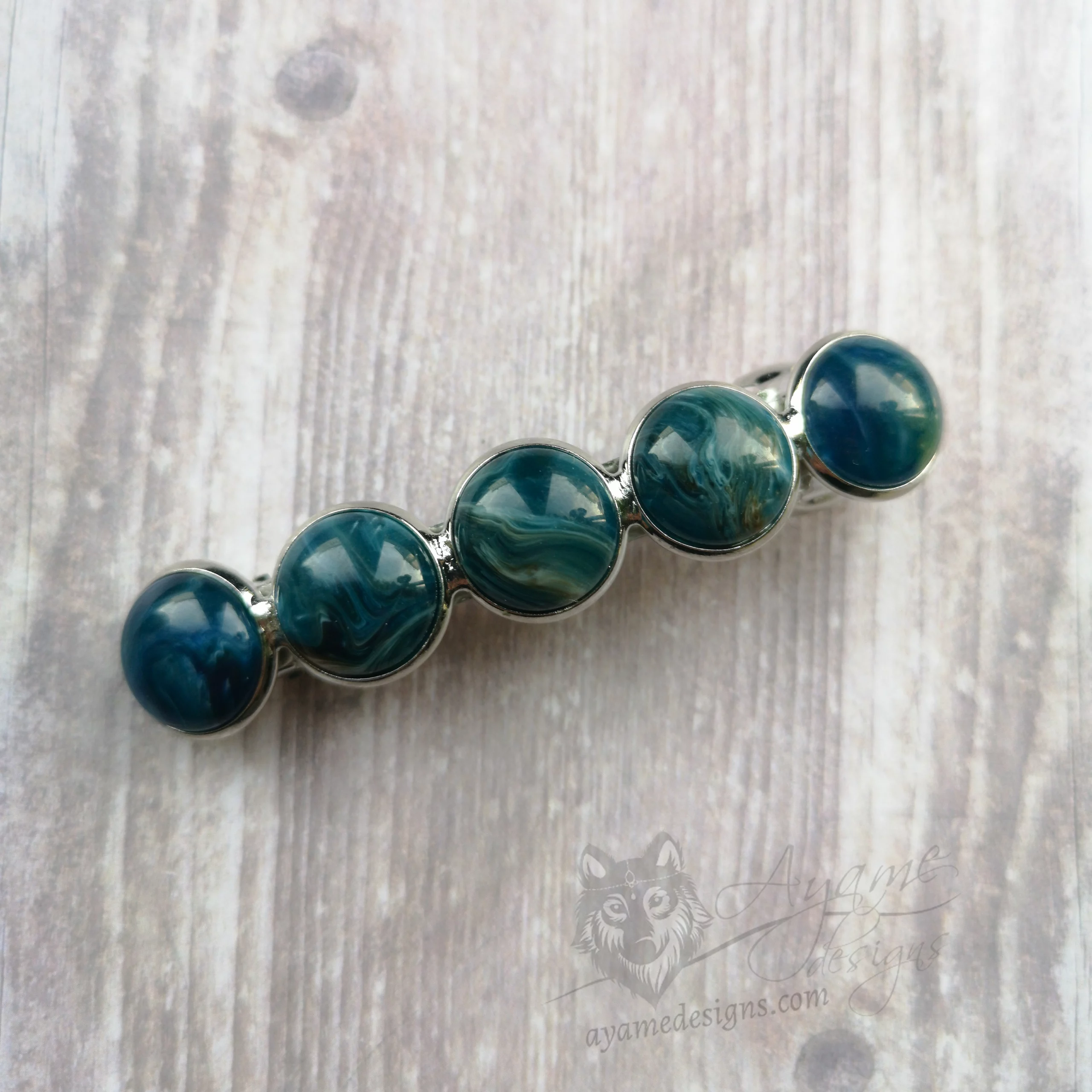 Hair barrette with blue marble swirl resin cabochons