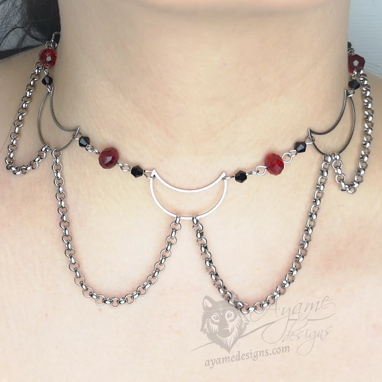 Handmade adjustable stainless steel choker necklace with stainless steel moons, black and red Austrian crystal beads, and stainless steel chain details
