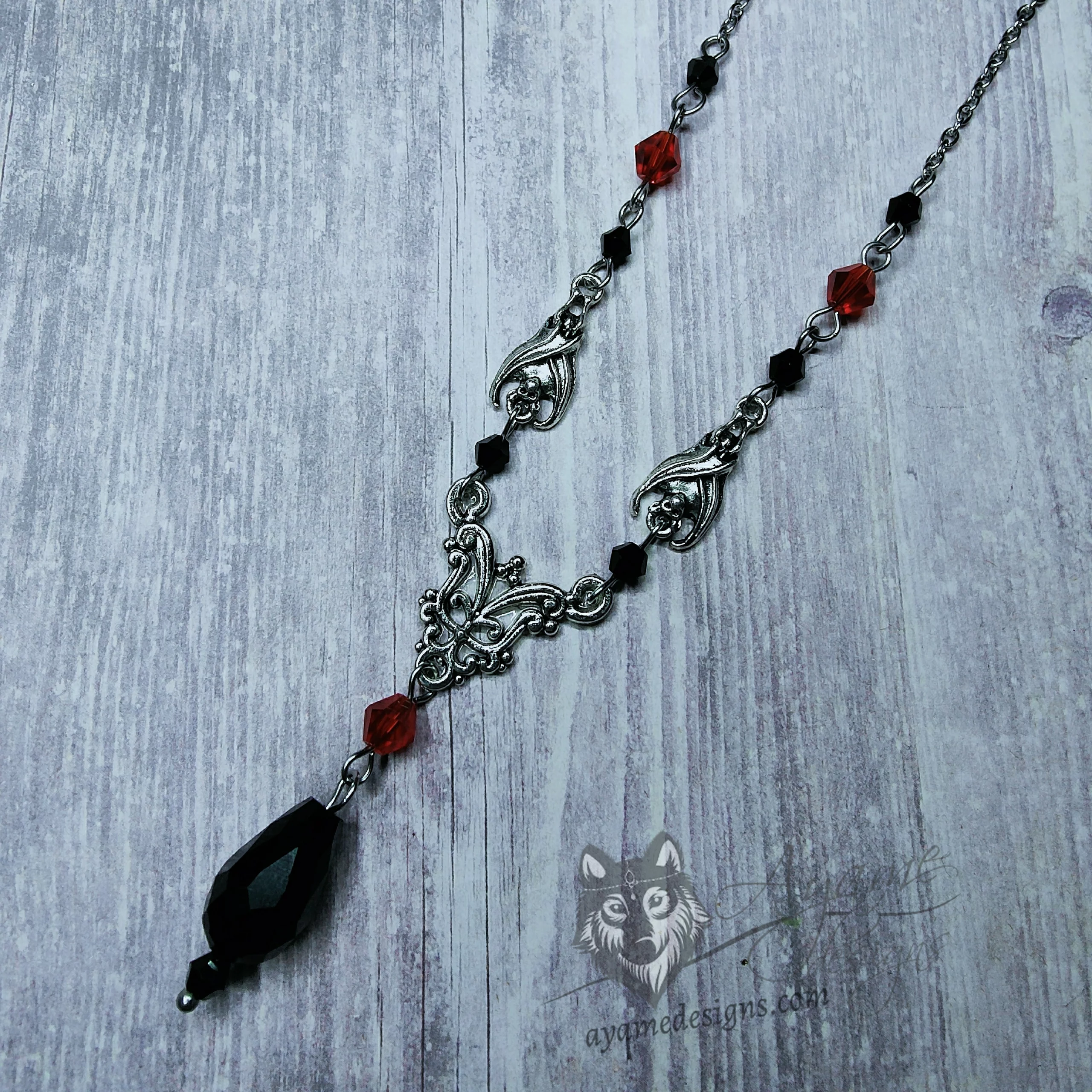Adjustable gothic necklace with small bat and filigree charms, with black and red Austrian crystal beads and stainless steel chain