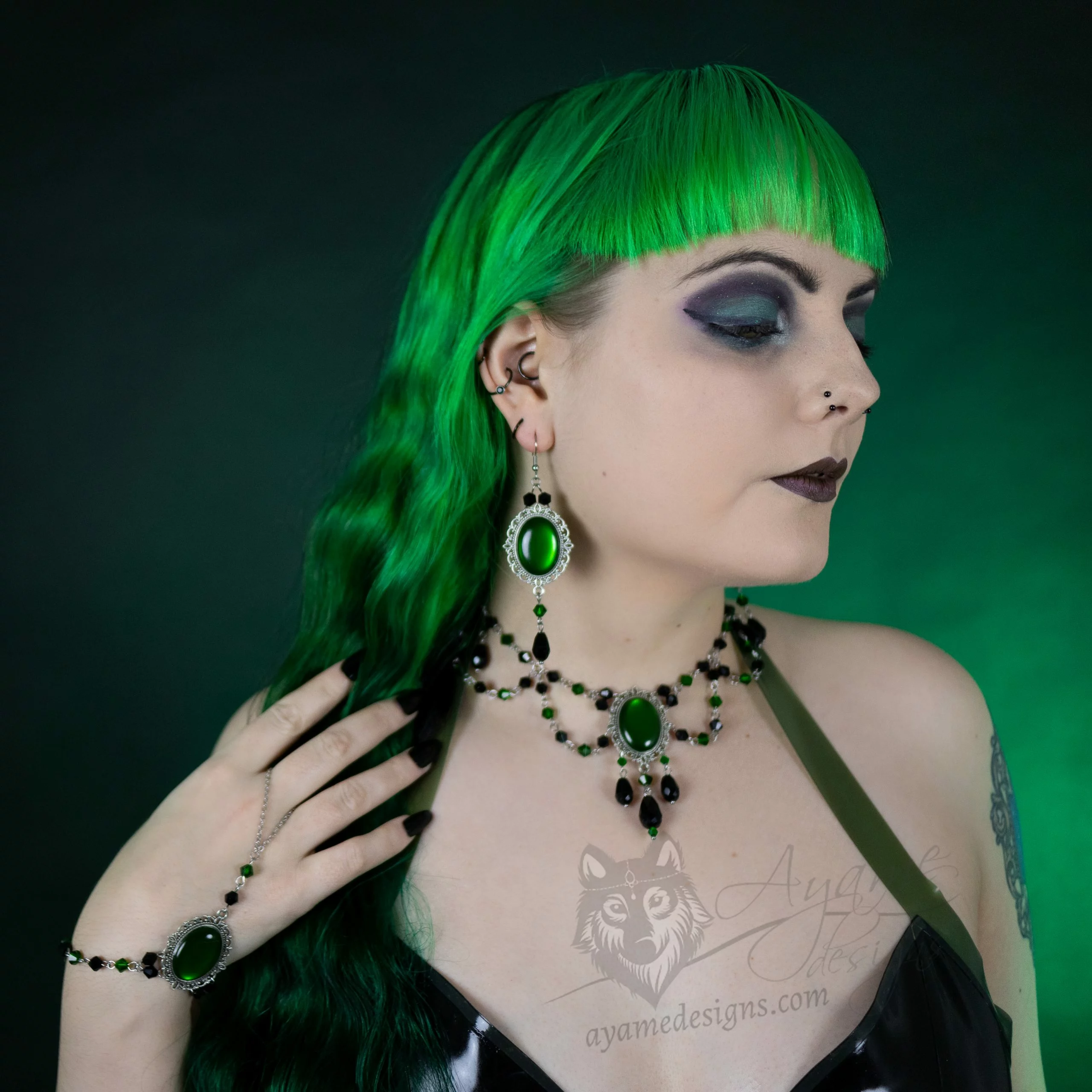 Gothic model wearing a handmade jewellery set with earrings, a beaded choker necklace and a hand bracelet
