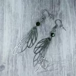 Handmade earrings with laser cut stainless steel fairy wing charms with green Austrian crystal beads, on stainless steel earring hooks